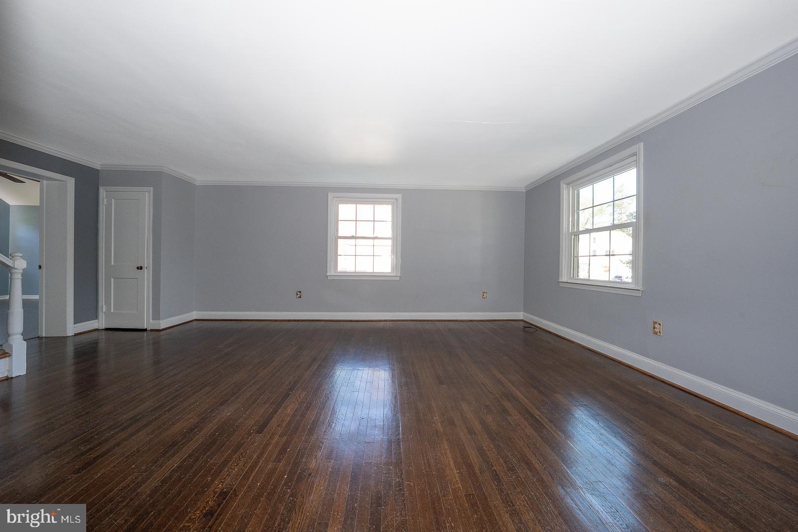 306 Sedgewood Road Springfield, PA 19064 - Photo 6 of 55 an empty room with wooden floor and windows