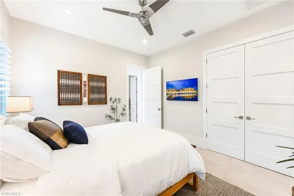 a bedroom with a bed and a large window