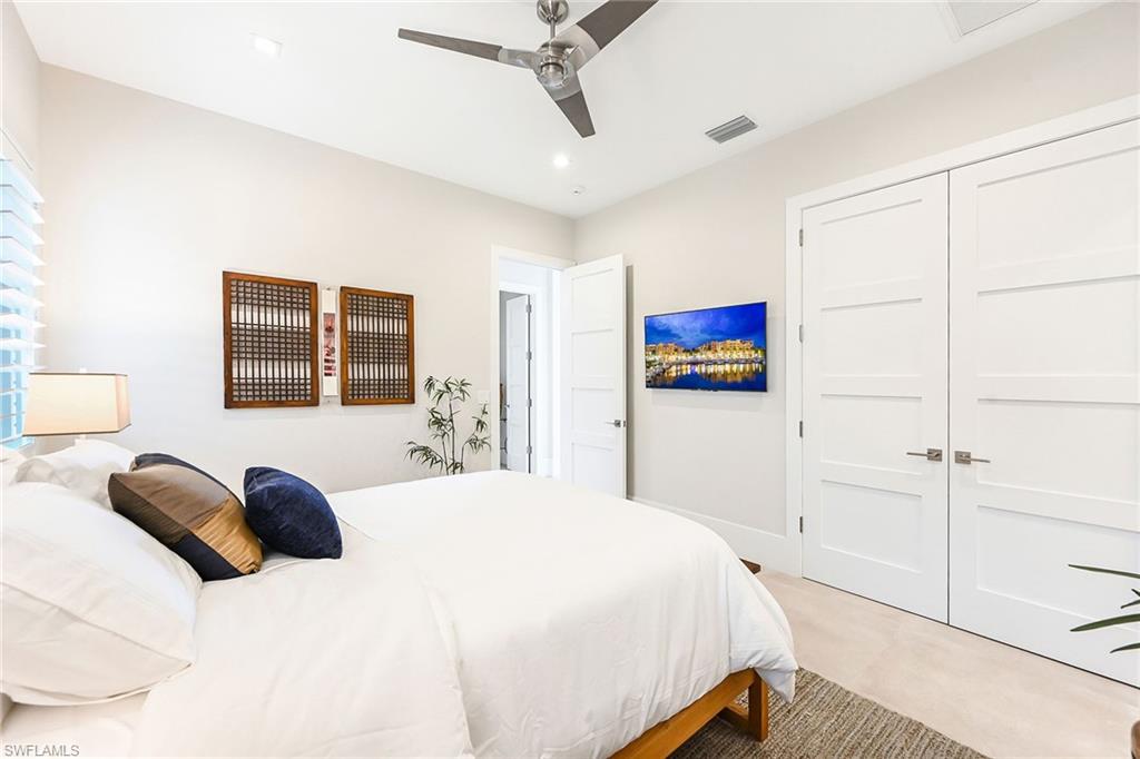 4646 Crayton Road Naples, FL 34103 - Photo 16 of 26 a bedroom with a bed and a large window