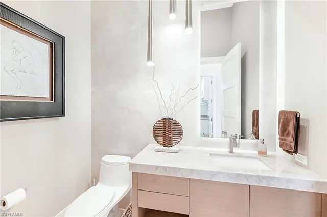 a bathroom with a sink a toilet and mirror