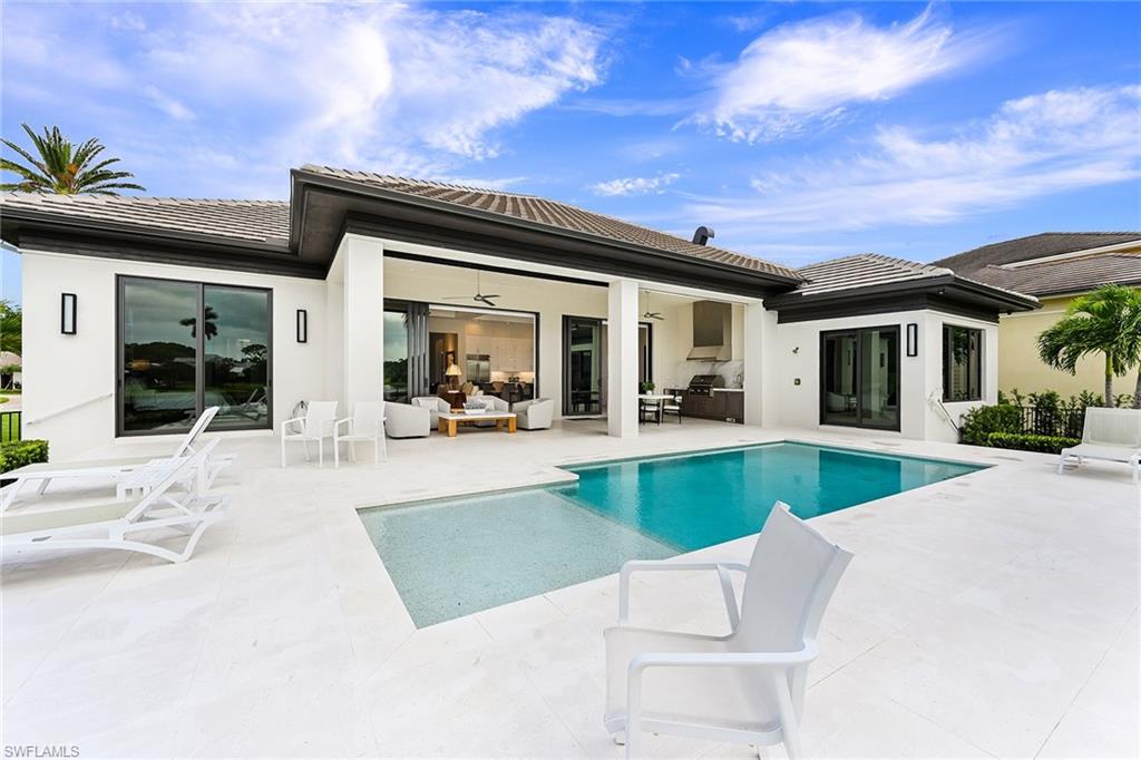 4646 Crayton Road Naples, FL 34103 - Photo 20 of 26 a view of swimming pool with outdoor seating