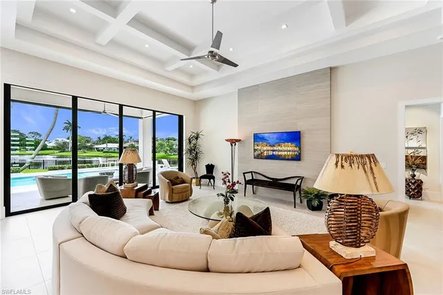 a living room with furniture large window and flat screen tv