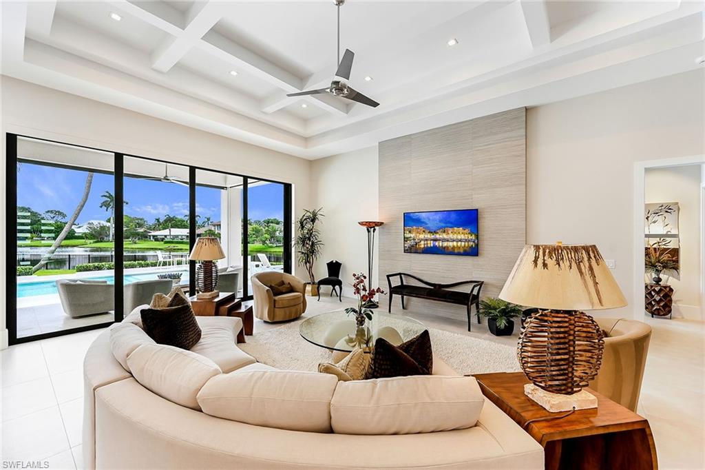 4646 Crayton Road Naples, FL 34103 - Photo 2 of 26 a living room with furniture large window and flat screen tv