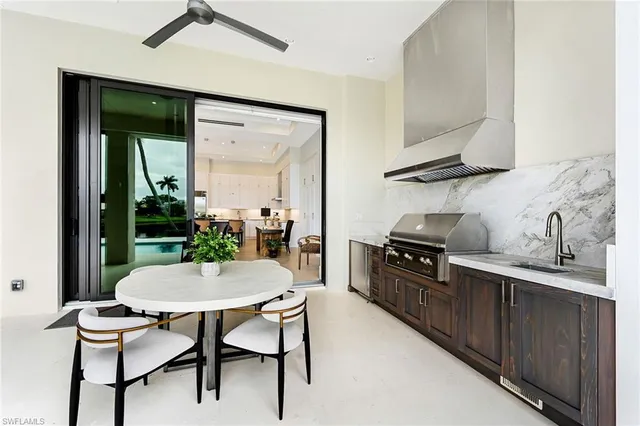 a kitchen with a table chairs stove and cabinets