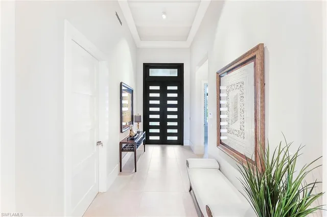 a view of a hallway with wooden floor and windows