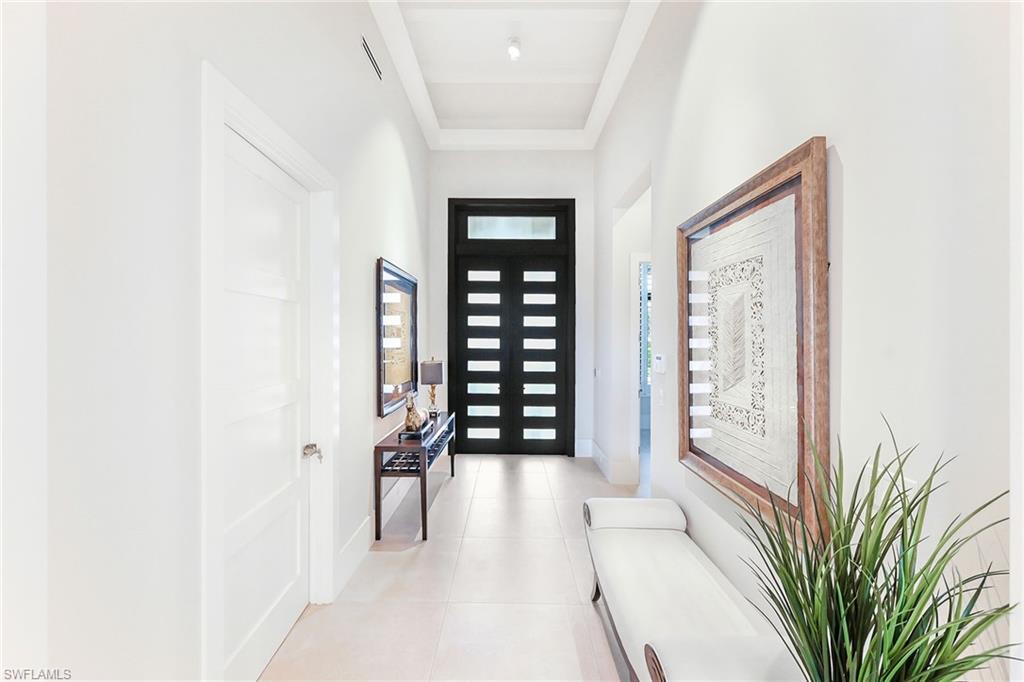 4646 Crayton Road Naples, FL 34103 - Photo 3 of 26 a view of a hallway with wooden floor and windows