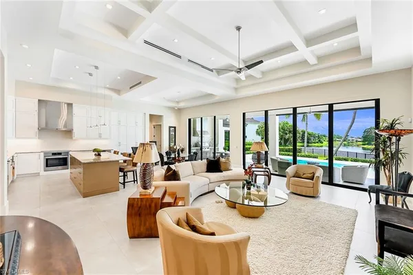 a view of a dining room with furniture large windows and wooden floor