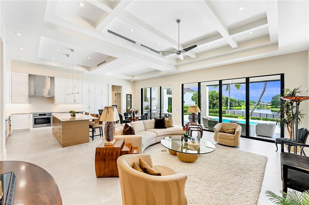 4646 Crayton Road Naples, FL 34103 - Photo 5 of 26 a view of a dining room with furniture large windows and wooden floor