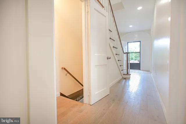 a view of an entryway with wooden floor