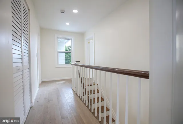 a view of hallway with wooden floor