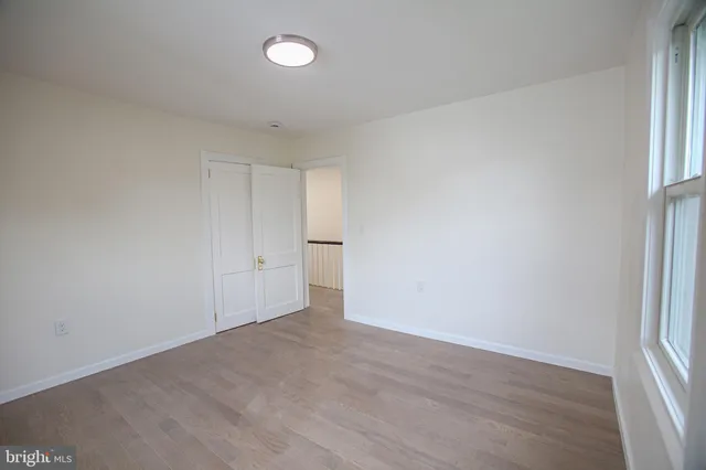 a view of an empty room and wooden floor