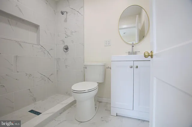 a bathroom with a toilet sink and shower