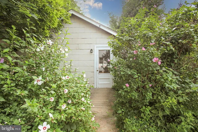 a yellow house with lots of flowers