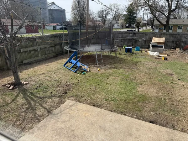 a view of backyard with wooden fence
