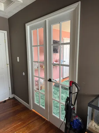 a view of room with wooden floor and windows