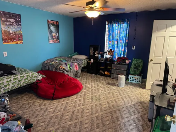 a bedroom with a bed dresser and a window