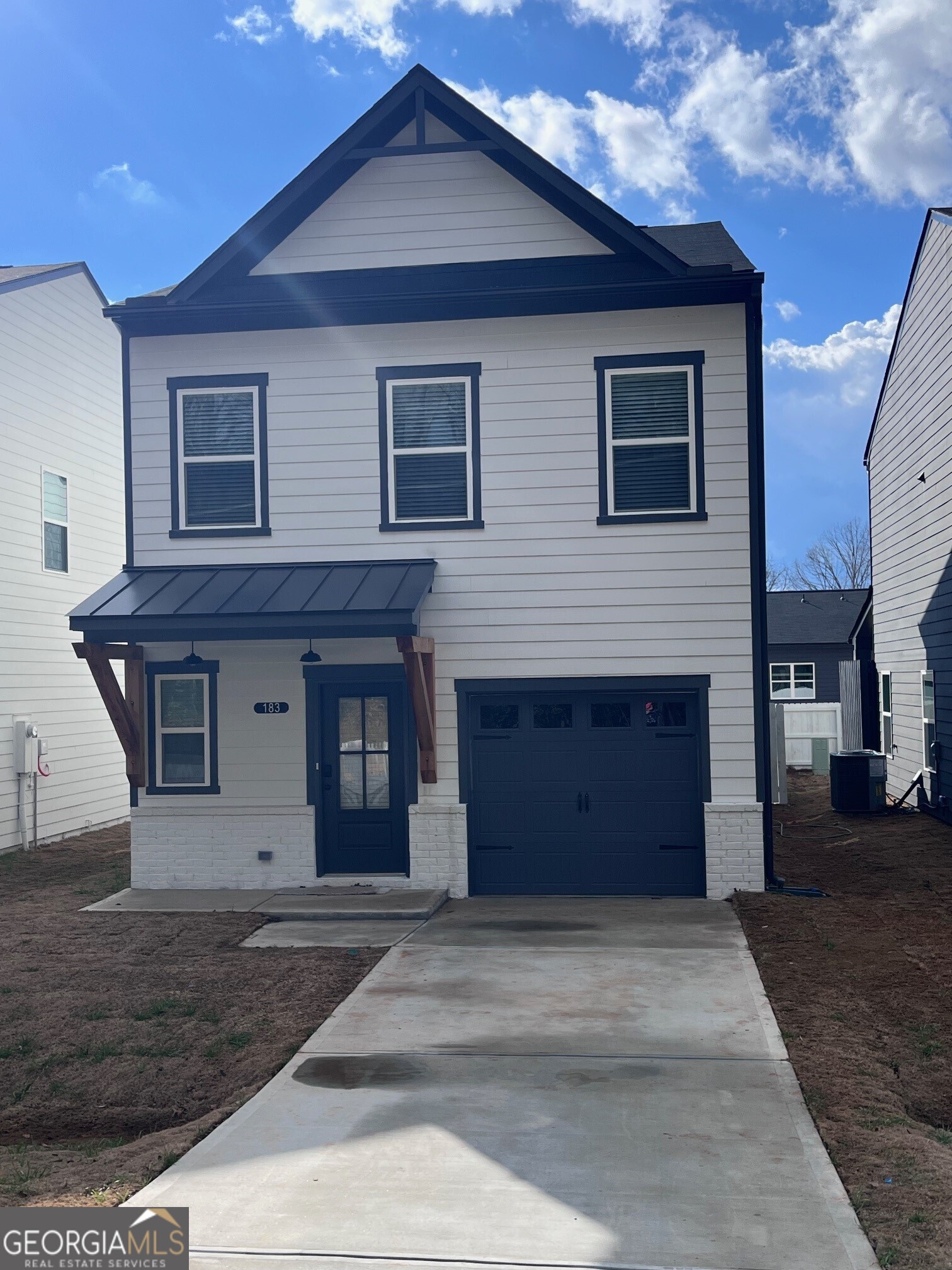 a front view of a house with a garden