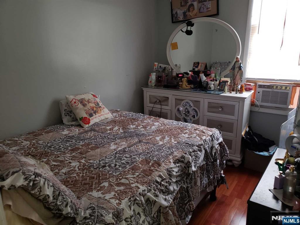 39 Tuttle Street Wallington, NJ 07057 - Photo 15 of 30 a bedroom with a bed and wooden floor
