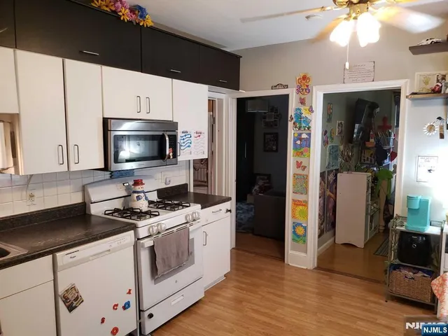 a kitchen with stainless steel appliances a stove a refrigerator and a sink