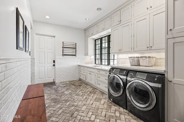 a kitchen with stainless steel appliances granite countertop a kitchen island hardwood floor a sink and a window
