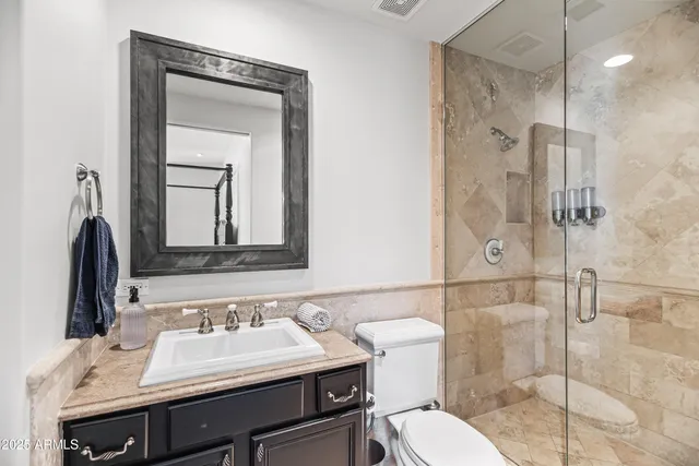 a bathroom with a sink toilet and shower