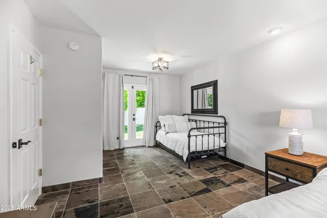 a bedroom with a bed and a window