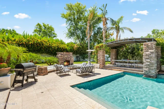 a swimming pool with outdoor seating and yard