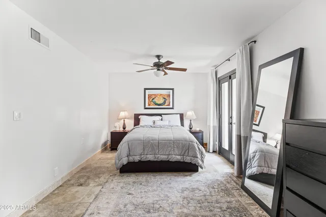 a bedroom with a bed and a chandelier