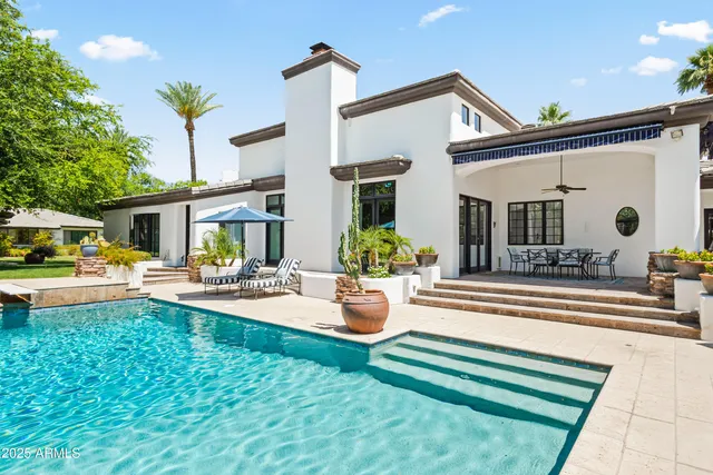 a front view of a house with swimming pool yard and patio