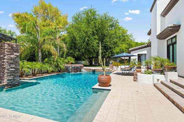 a view of a backyard with sitting area and garden