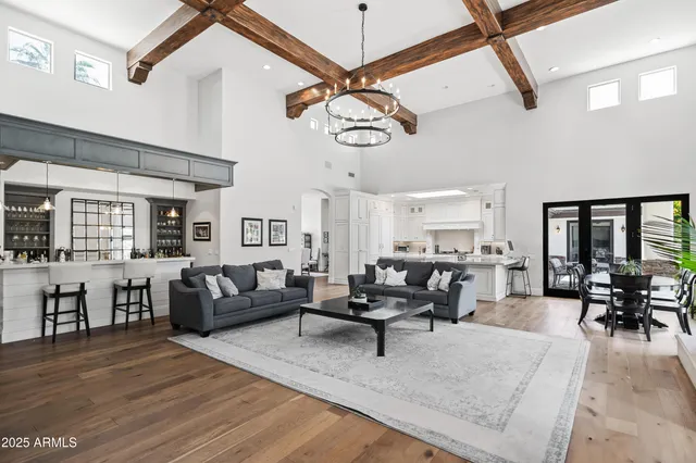 a kitchen with a stove a sink a dining table and chairs