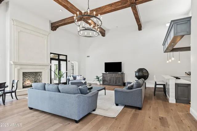 a living room with furniture wooden floor and a fireplace