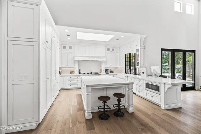 a view of living room with furniture white cabinets and wooden floor