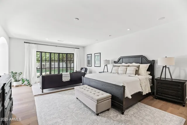 a bedroom with a bed couch and a window