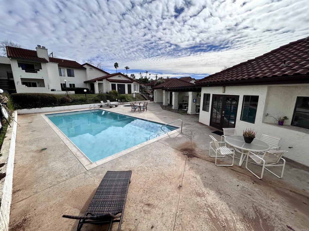 2425 Cranston Drive, Unit 204 Escondido, CA 92025 - Photo 15 of 17 a view of a patio with table and chairs with wooden floor and barbeque
