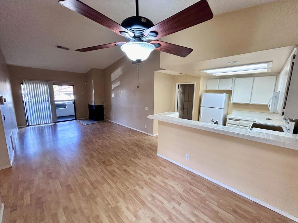 2425 Cranston Drive, Unit 204 Escondido, CA 92025 - Photo 4 of 17 a view of a room with wooden floor and a ceiling fan