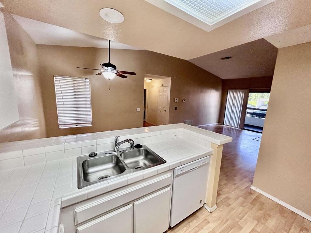 2425 Cranston Drive, Unit 204 Escondido, CA 92025 - Photo 5 of 17 a kitchen with a stove and a hallway