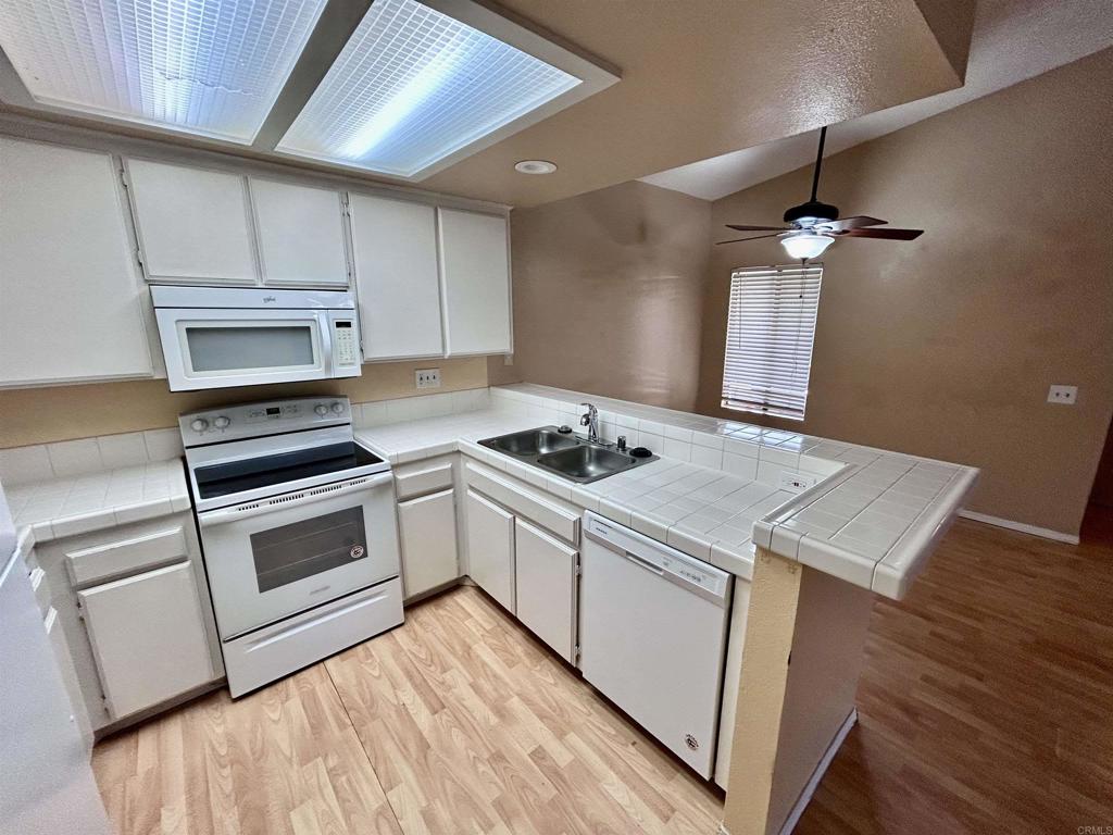 2425 Cranston Drive, Unit 204 Escondido, CA 92025 - Photo 6 of 17 a kitchen with a stove and a microwave