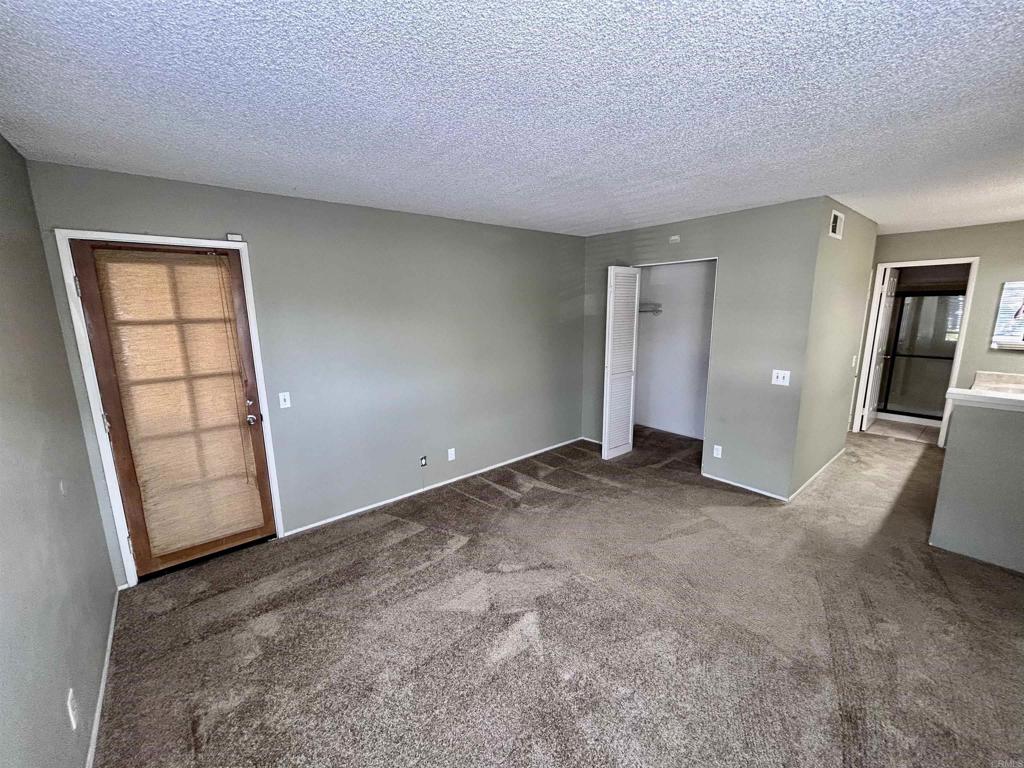 2425 Cranston Drive, Unit 204 Escondido, CA 92025 - Photo 8 of 17 an empty room with windows and closet