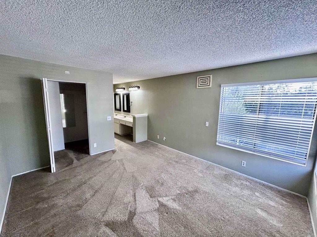 2425 Cranston Drive, Unit 204 Escondido, CA 92025 - Photo 9 of 17 a view of empty room with a fireplace