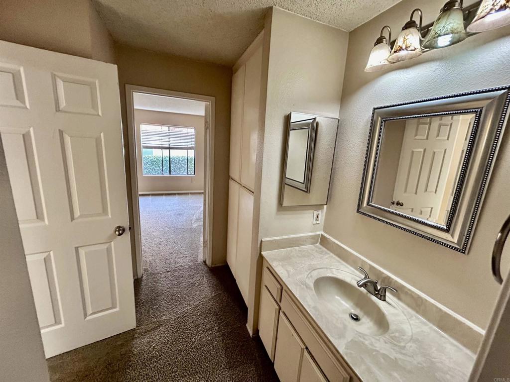 2425 Cranston Drive, Unit 204 Escondido, CA 92025 - Photo 10 of 17 a bathroom with a tub sink and mirror