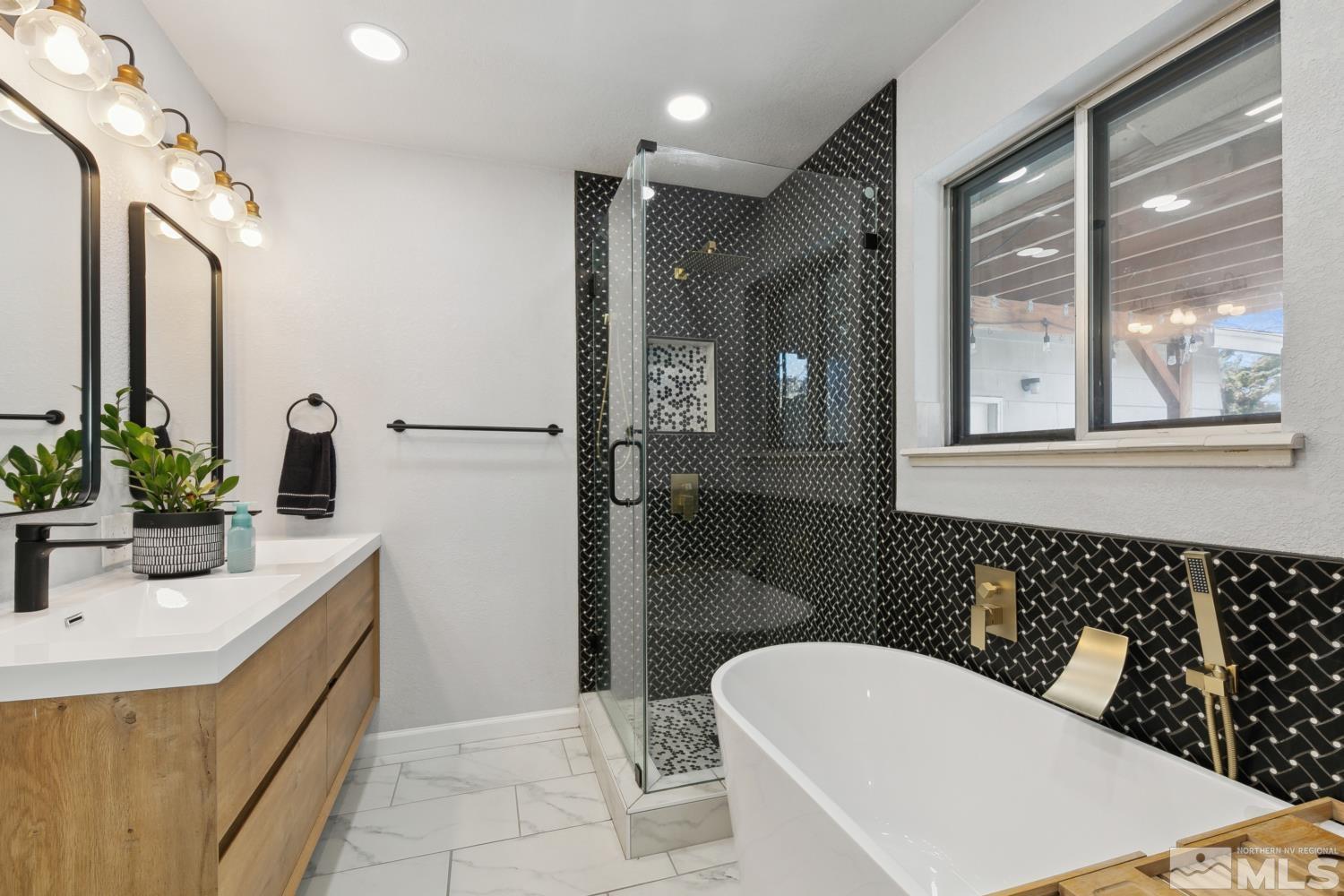 3175 Bryan Street Reno, NV 89503 - Photo 13 of 18 a bathroom with a sink a toilet a mirror and shower