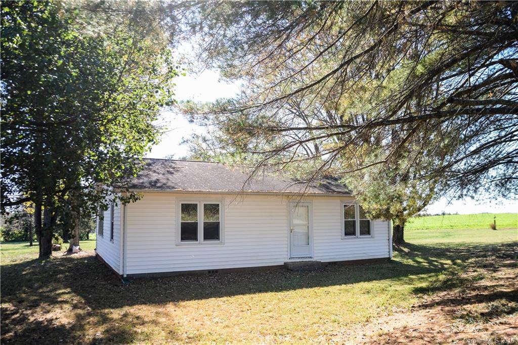 139 Duncan Road Olin, NC 28660 - Photo 1 of 24 a view of a house with a yard tree and a garden