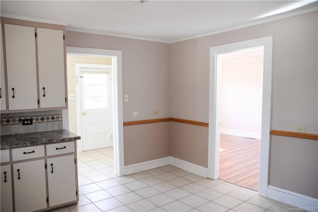 139 Duncan Road Olin, NC 28660 - Photo 14 of 24 a view of kitchen with granite countertop cabinets and entryway