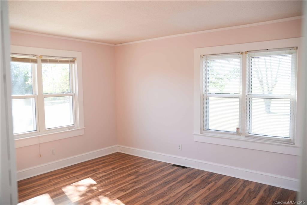 139 Duncan Road Olin, NC 28660 - Photo 22 of 24 an empty room with wooden floor and windows