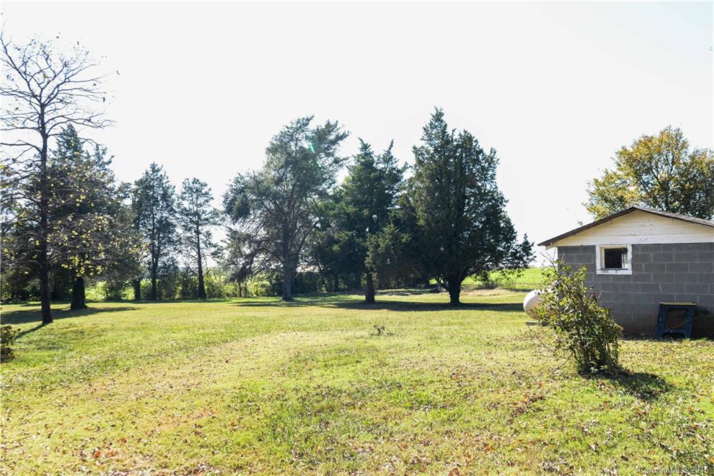 139 Duncan Road Olin, NC 28660 - Photo 9 of 24 a view of a house with a big yard and large trees