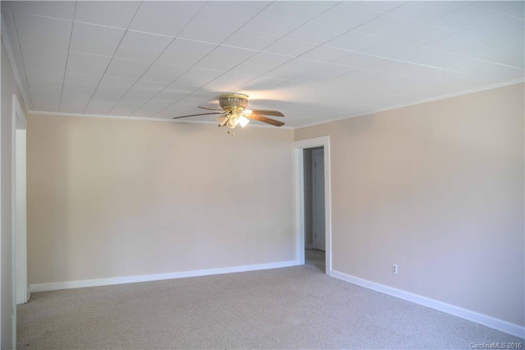 139 Duncan Road Olin, NC 28660 - Photo 10 of 24 an empty room with a chandelier fan