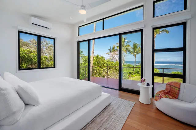 a bedroom with a large bed and a large window