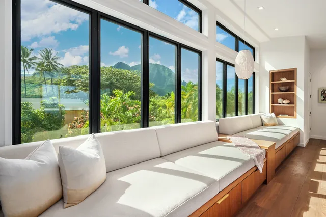 a living room with furniture and large windows