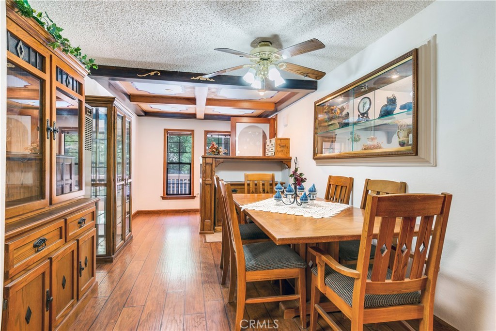 9339 Wood Road Forest Falls, CA 92339 - Photo 18 of 48 a view of a dining room with furniture window and wooden floor